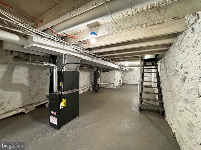 basement featuring gas water heater and heating unit