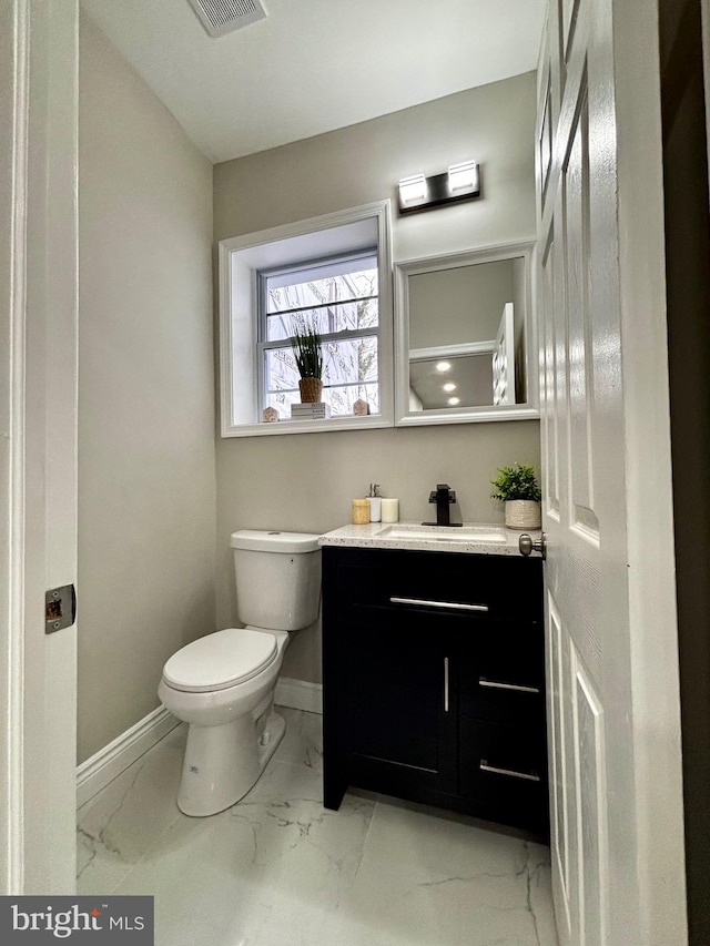 bathroom with vanity and toilet