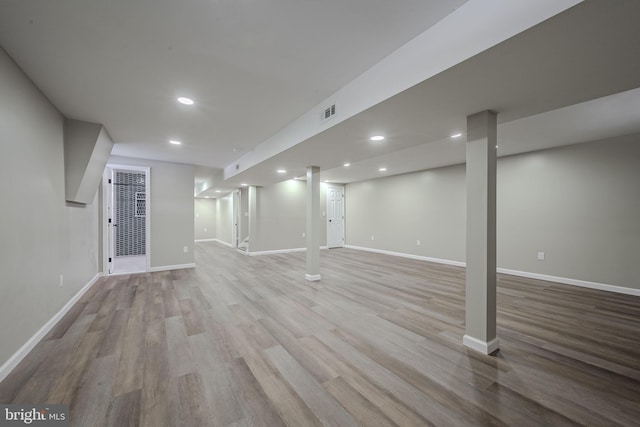 basement with light hardwood / wood-style floors