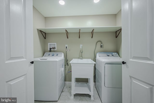 clothes washing area with washer and clothes dryer