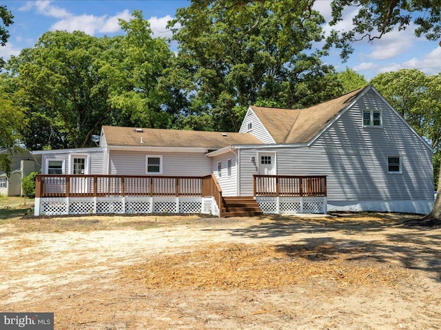 back of property with a wooden deck