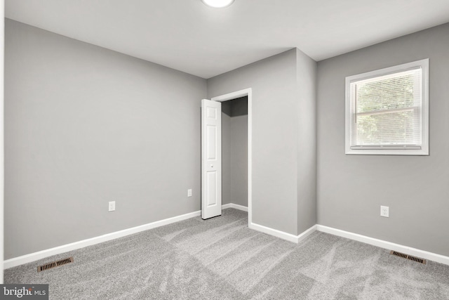 unfurnished bedroom featuring light carpet