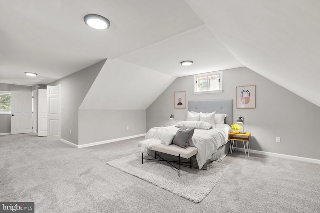 carpeted bedroom featuring vaulted ceiling