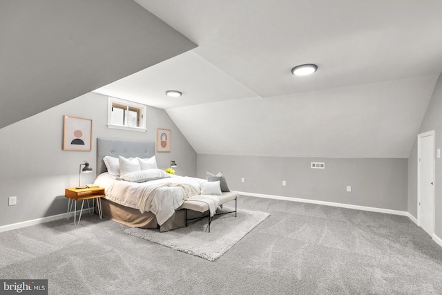 bedroom with vaulted ceiling and carpet flooring