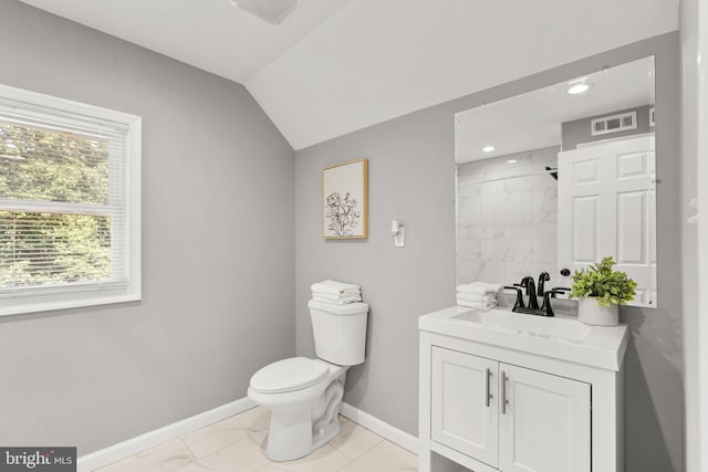 bathroom featuring toilet, vaulted ceiling, walk in shower, and vanity