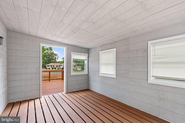 unfurnished sunroom with lofted ceiling