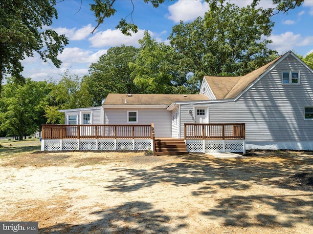 rear view of property with a wooden deck