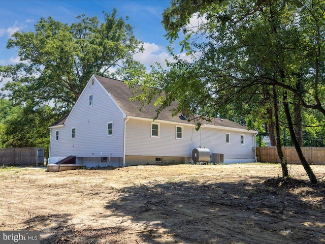 back of property featuring central AC