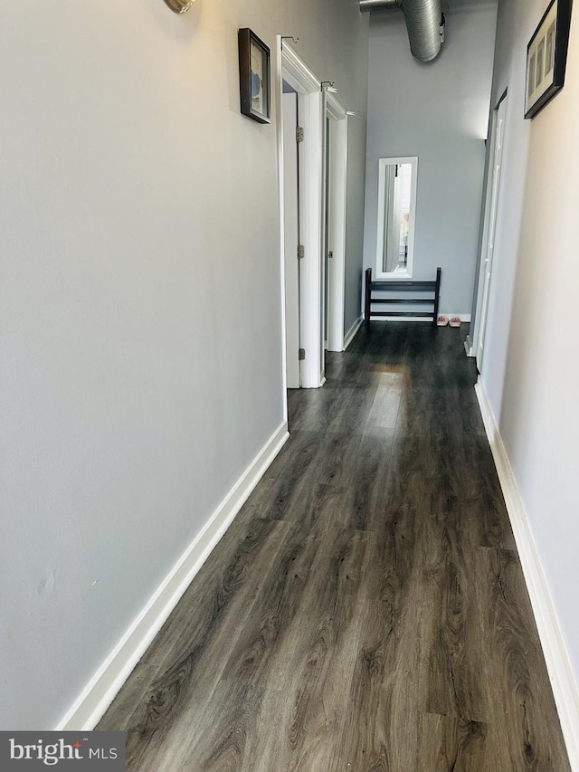 hall with dark wood-type flooring