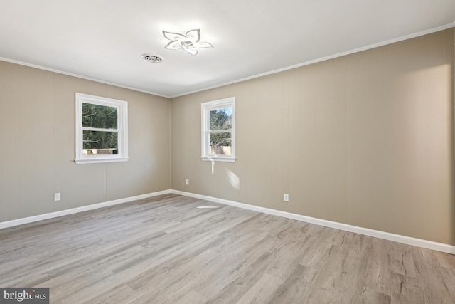 unfurnished room featuring ornamental molding and light hardwood / wood-style floors