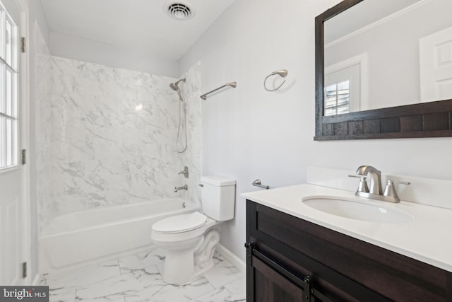 full bathroom featuring tiled shower / bath combo, vanity, and toilet