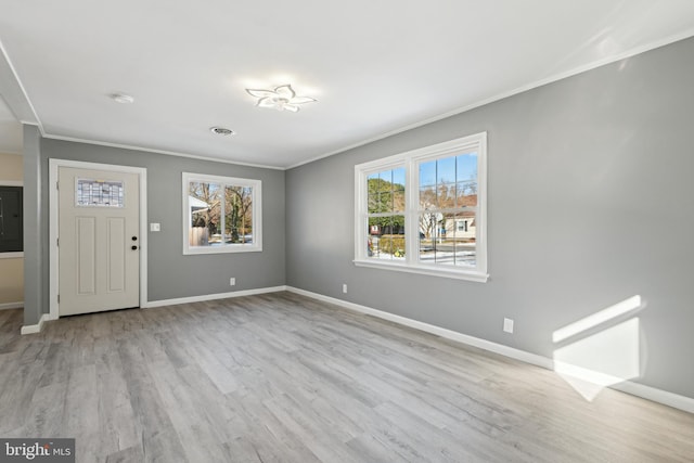 entrance foyer featuring light wood-type flooring and ornamental molding