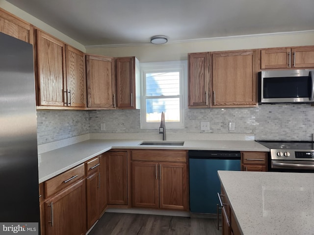 kitchen with light stone countertops, stainless steel appliances, sink, backsplash, and dark hardwood / wood-style floors