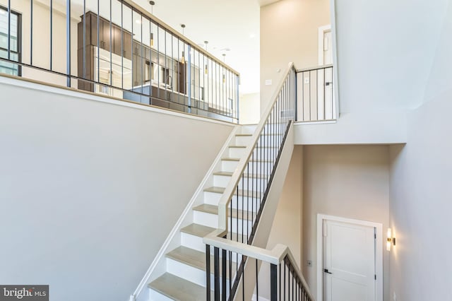 stairway featuring a high ceiling