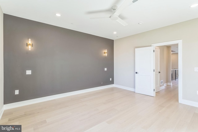 unfurnished room with ceiling fan and light hardwood / wood-style floors