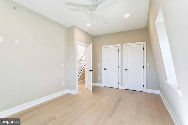 unfurnished bedroom with ceiling fan and light wood-type flooring