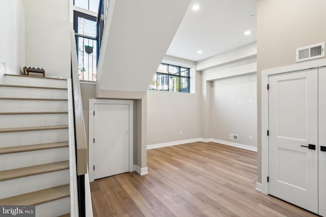 stairs featuring wood-type flooring