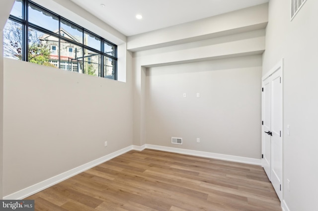 spare room with hardwood / wood-style floors