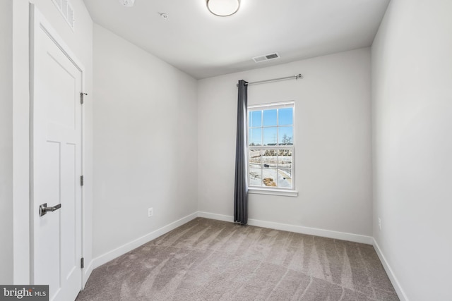 unfurnished room featuring light colored carpet