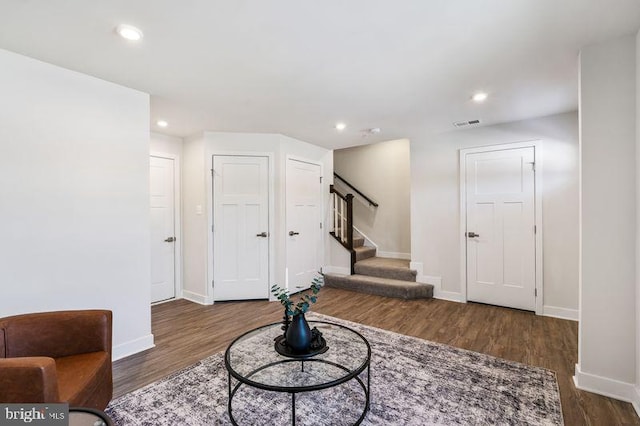 sitting room with dark wood-type flooring