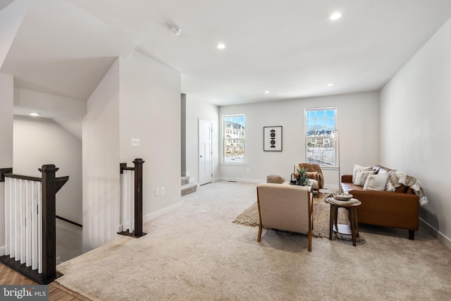 living area featuring light carpet