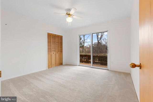 unfurnished bedroom featuring carpet floors, a closet, a ceiling fan, and access to exterior