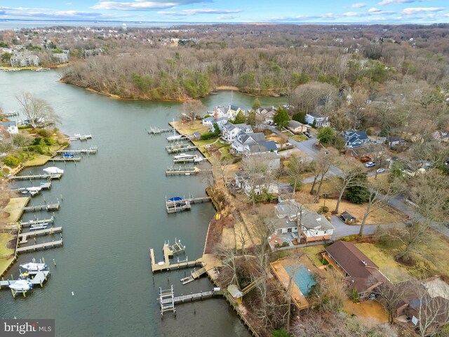 drone / aerial view featuring a water view and a view of trees