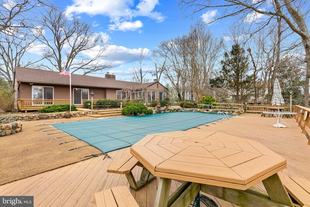 view of pool featuring a patio area, a covered pool, and a deck