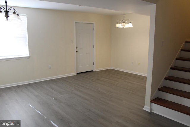 interior space with dark hardwood / wood-style floors and a chandelier