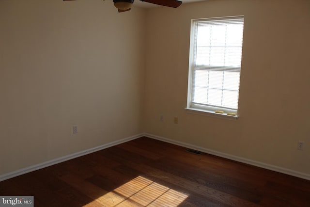 empty room featuring ceiling fan and dark wood-type flooring