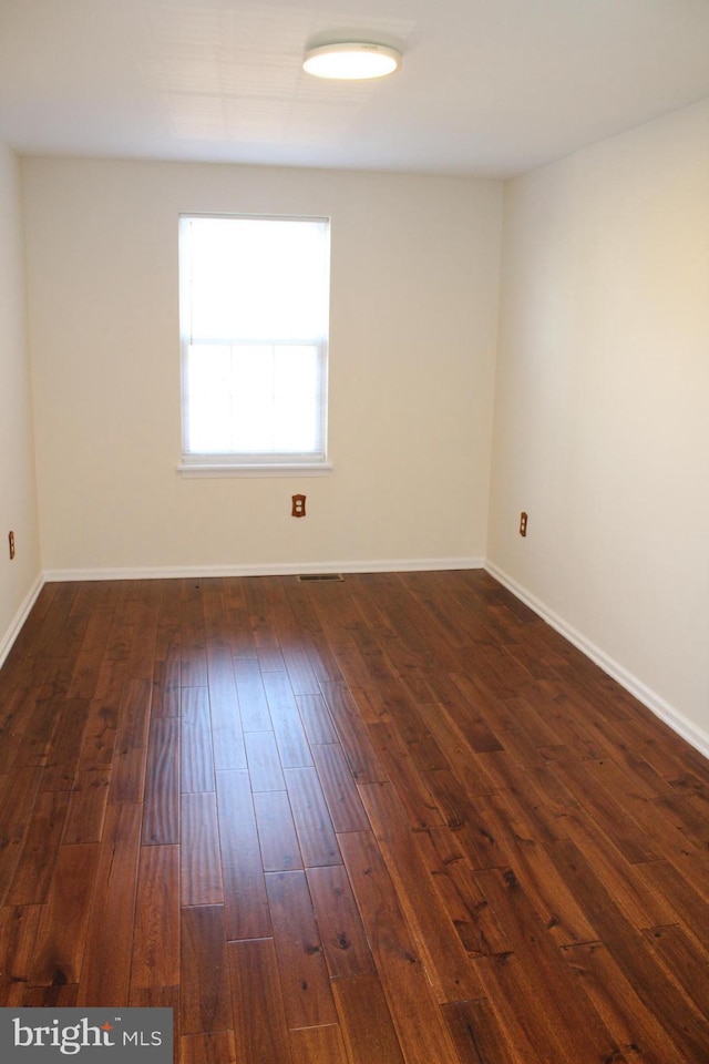 unfurnished room with dark hardwood / wood-style floors