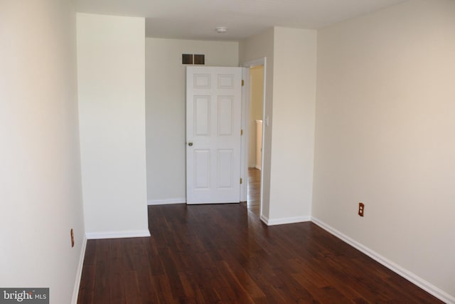 empty room featuring dark hardwood / wood-style flooring