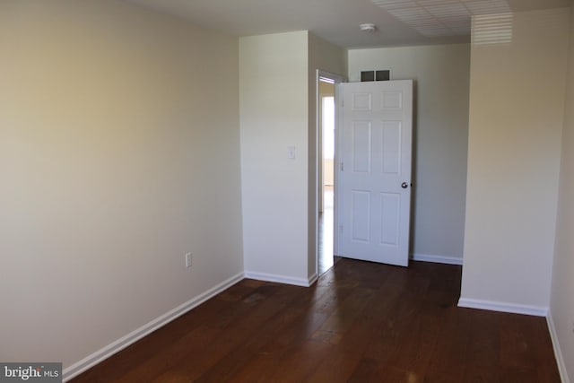 unfurnished room featuring dark hardwood / wood-style flooring