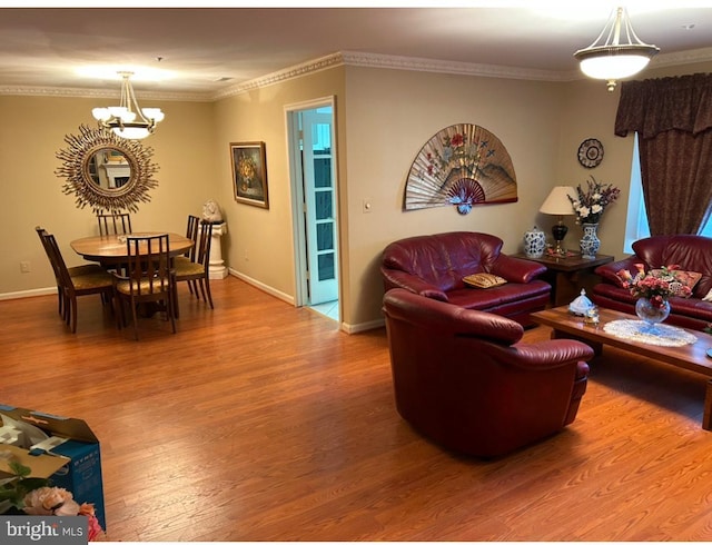 living room featuring ornamental molding, hardwood / wood-style floors, and a chandelier