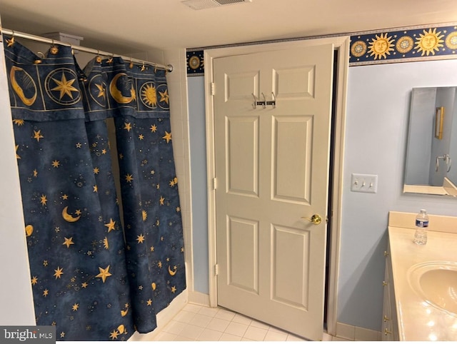 interior space featuring vanity, tile patterned floors, and walk in shower