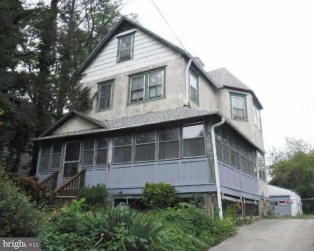 view of home's exterior with a sunroom