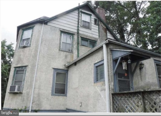 view of side of home featuring cooling unit