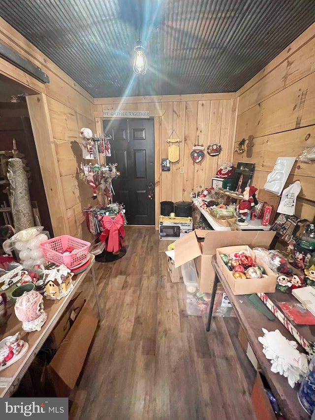 miscellaneous room featuring dark hardwood / wood-style floors and wood walls