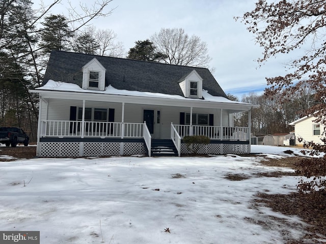 cape cod house featuring a porch