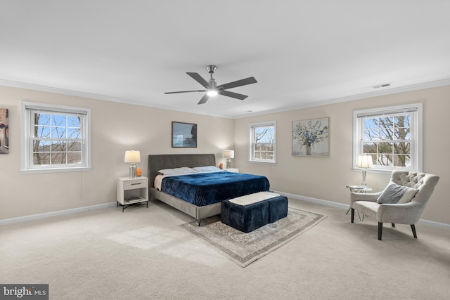 carpeted bedroom featuring ceiling fan, crown molding, and multiple windows