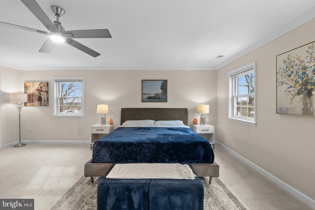 carpeted bedroom featuring ceiling fan and ornamental molding