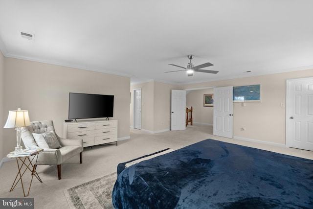 bedroom with ceiling fan, crown molding, and light colored carpet