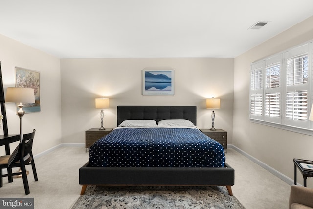 bedroom featuring light colored carpet