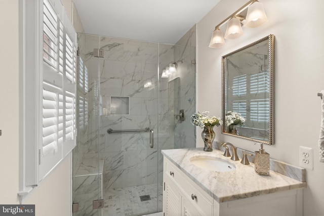 bathroom with vanity and a shower with door