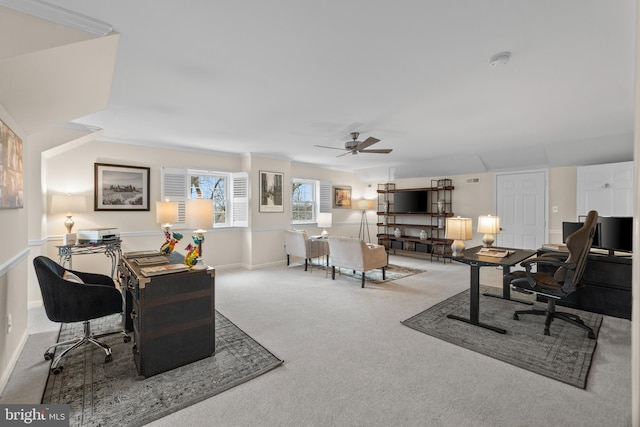 carpeted office space featuring ceiling fan