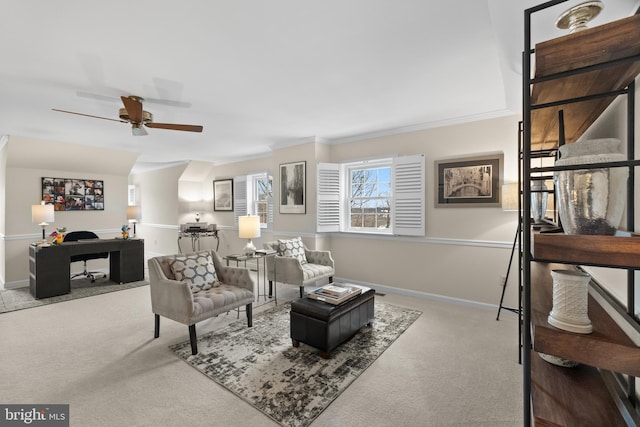 living room featuring ceiling fan, ornamental molding, and light colored carpet