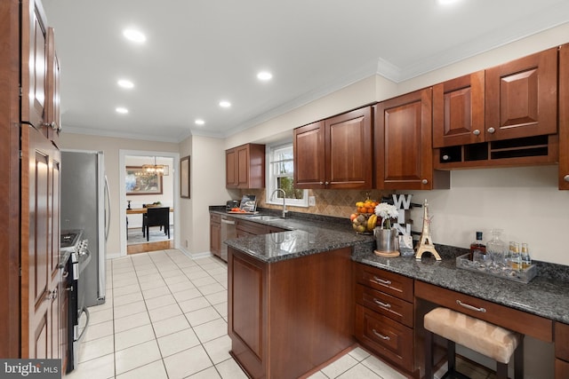 kitchen featuring stainless steel appliances, a notable chandelier, dark stone countertops, ornamental molding, and sink