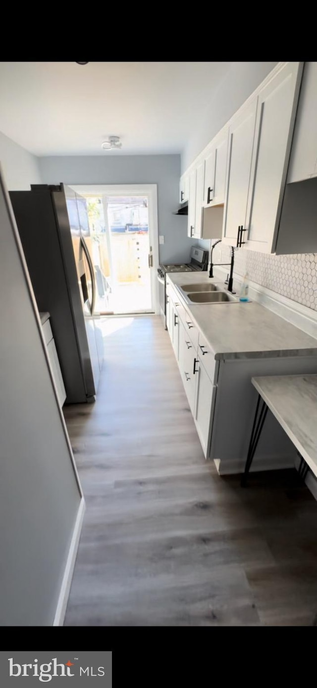 kitchen featuring white cabinets, dark wood-type flooring, sink, and stainless steel appliances