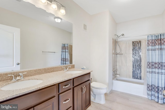 full bathroom with shower / bathtub combination with curtain, vanity, and toilet