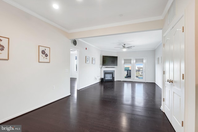 unfurnished living room featuring crown molding, ceiling fan, and dark hardwood / wood-style flooring